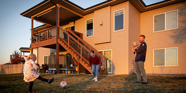 Dan and his family playing soccer in their backyard