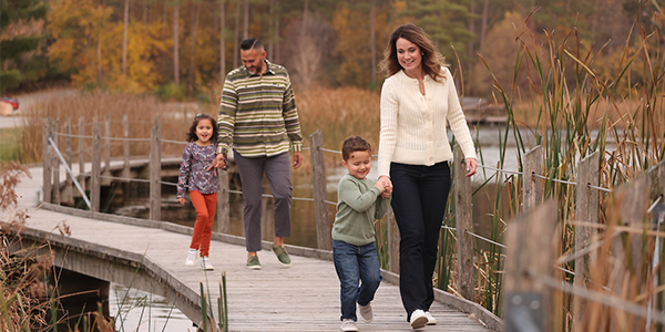 A family walking on a path at Jester Park in the fal