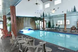 Chairs are surrounding the pool and at the back, there is small opening where swimmers can swim through to get outside.